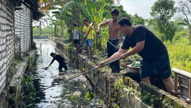 Reza Teguh Wibowo bersama warga saat melakukan kerja bakti pembersihan di sepanjang Kali Kepang, Kampung Tarogan, Kelurahan Kemayoran, Kecamatan Bangkalan, Minggu (21/12/2025).