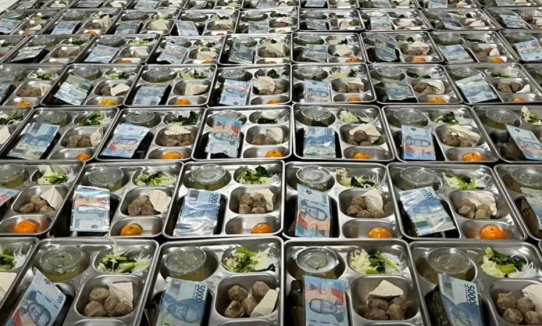 Ribuan ompreng Makan Bergizi Gratis (MBG) di Kecamatan Tanah Merah, Bangkalan, berjejer rapi dengan sisipan uang Rp 50 ribu di setiap paket, siap dibagikan kepada 1.877 siswa penerima manfaat.