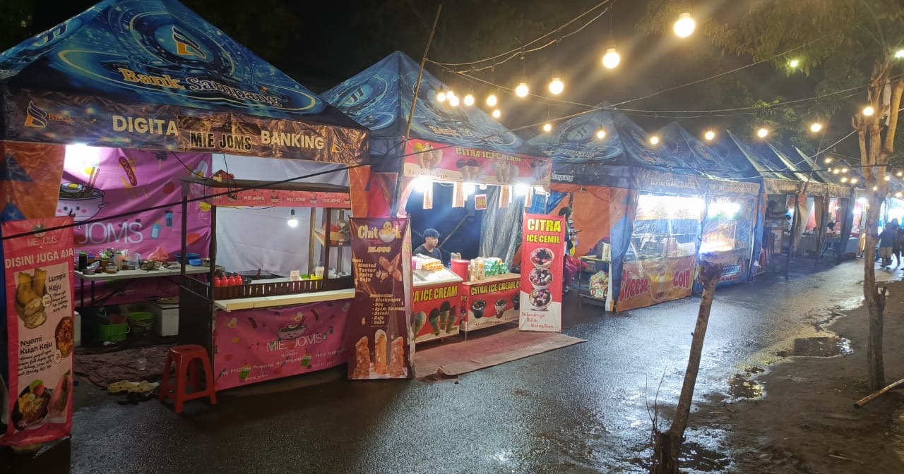 Deretan stan pelaku UMKM berjajar rapi memeriahkan Festival Bazar UMKM di Pasar Margalela, Kabupaten Sampang, Rabu (4/2/2026). Kegiatan yang berlangsung selama 15 hari ini menghadirkan puluhan UMKM dengan aneka produk kuliner dan kerajinan, sekaligus menghidupkan kembali aktivitas ekonomi pasar tradisional.